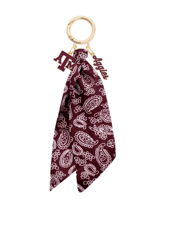 Maroon paisley patterned keychain with gold ring and keyring on a white background