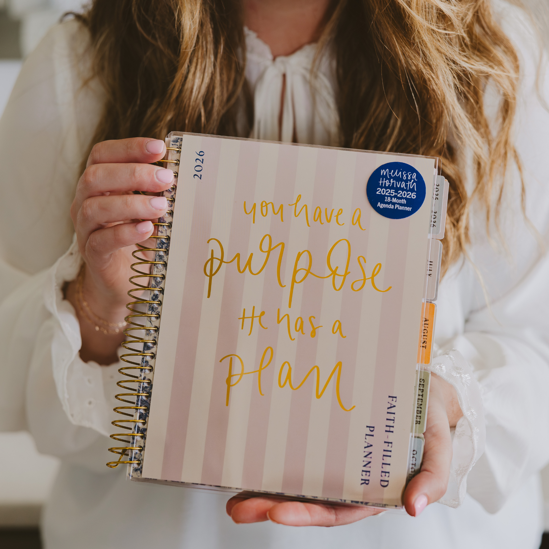 Person holding a planner with motivational quote