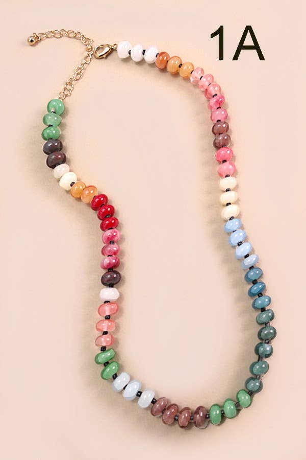 Colorful beaded necklace on a beige background