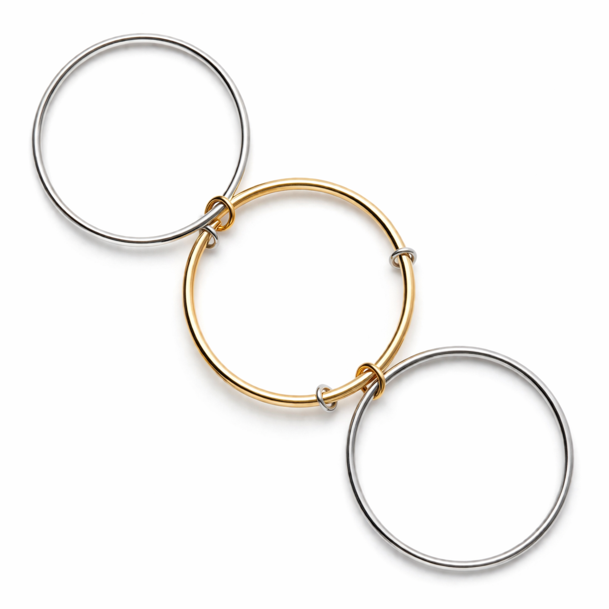 Three interlocking circular hoop earrings in silver and gold-tone metals, arranged diagonally on a clean white background.