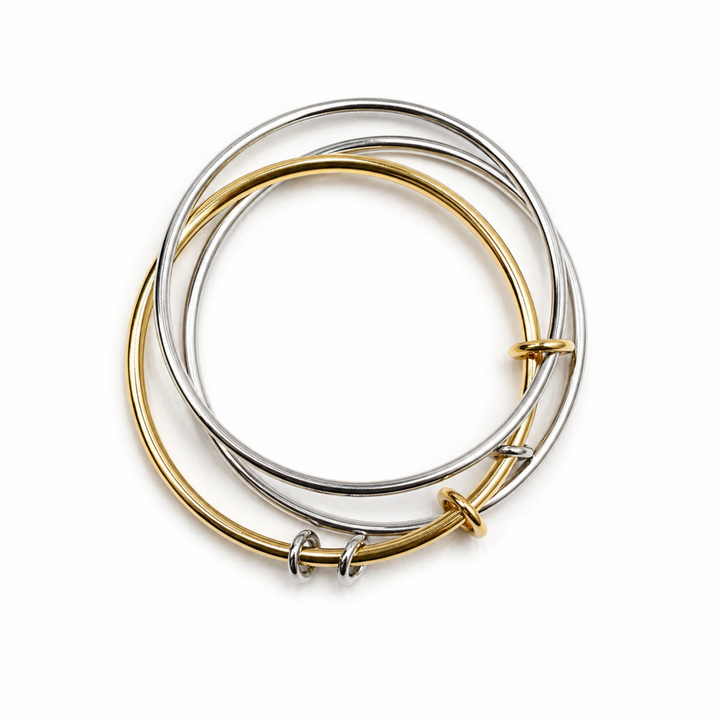 Two gold and silver bangles stacked on a white background
