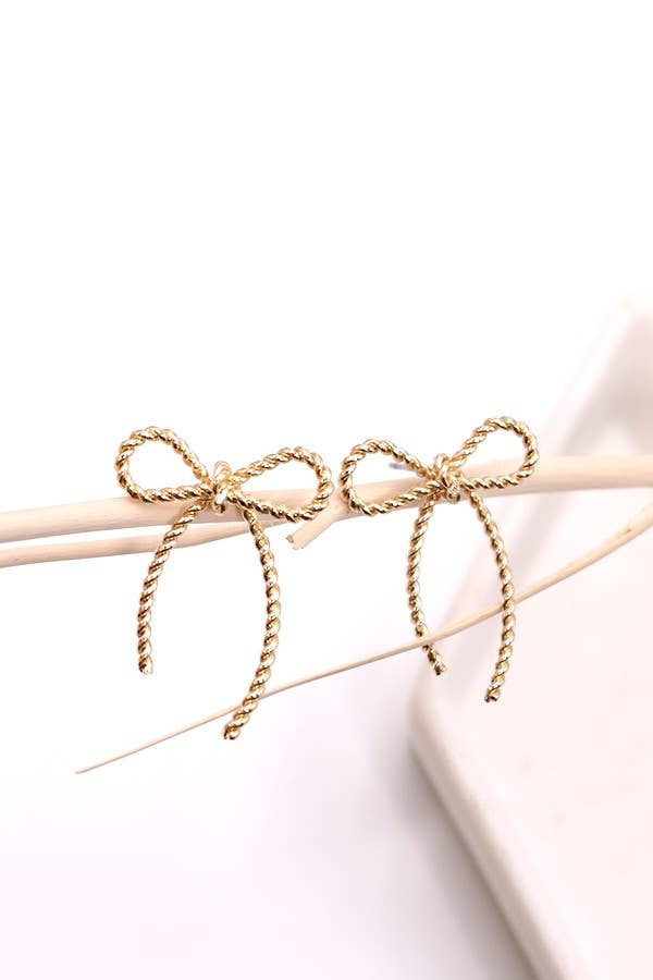 Gold bow-shaped earrings on a white background