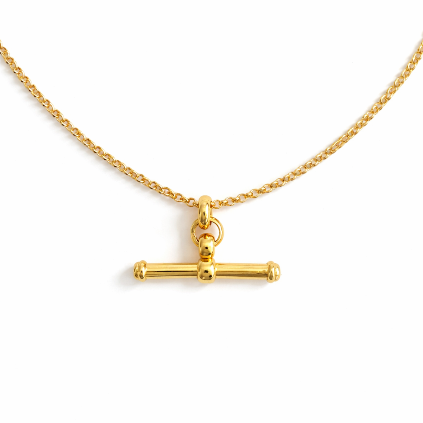 Gold necklace with a cylindrical pendant on a white background