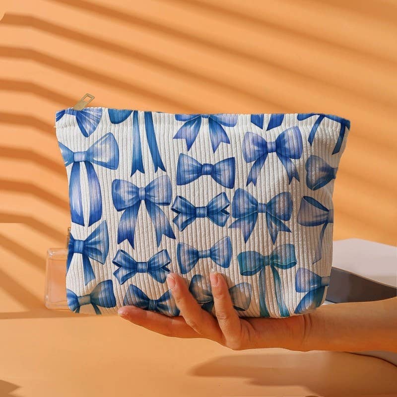 Pouch with blue bow pattern held by a hand on an orange background