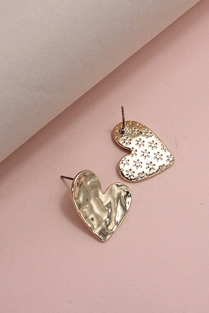 Heart-shaped earrings on a pink background