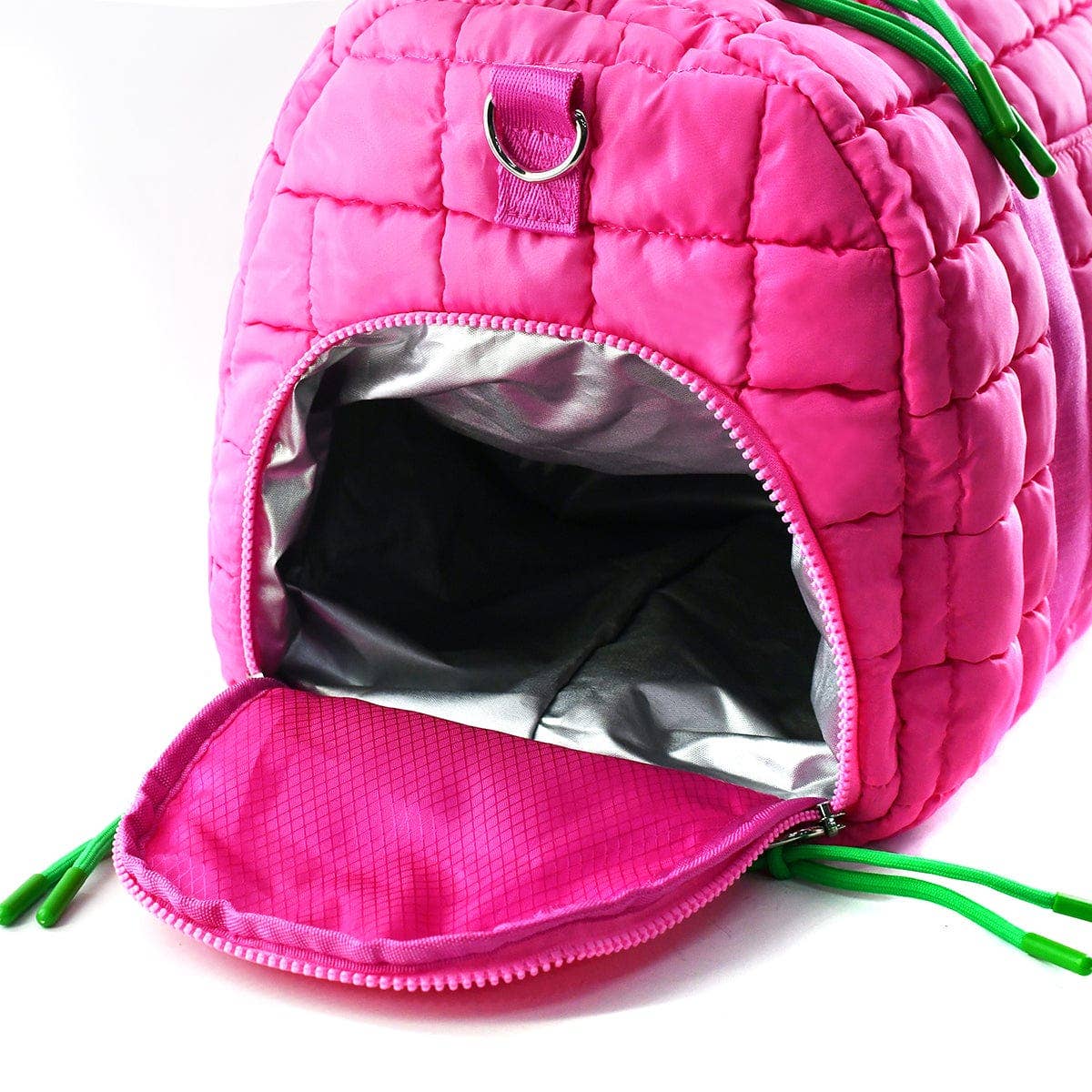 Pink quilted pet house with green straps on a white background