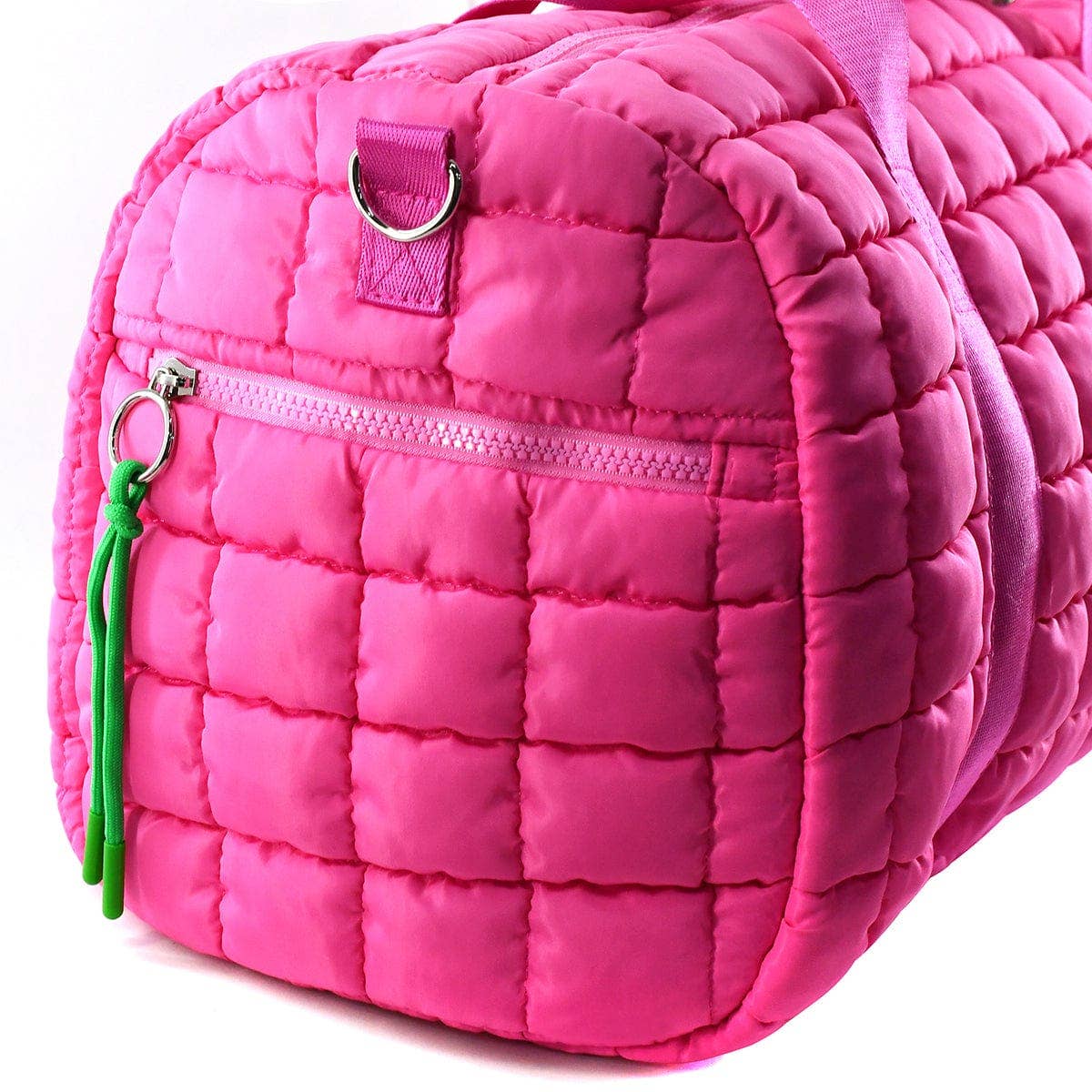Pink quilted bag with a green zipper pull on a white background