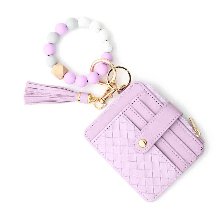 Pink woven cardholder with tassel keychain on a white background