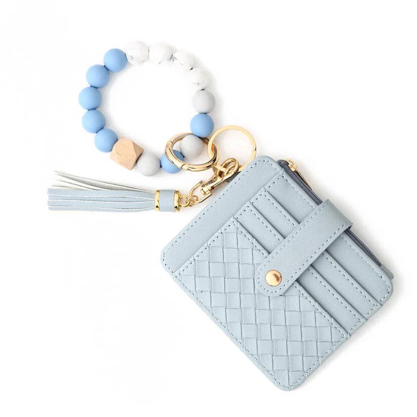 Light blue woven cardholder with tassel and keychain on a white background
